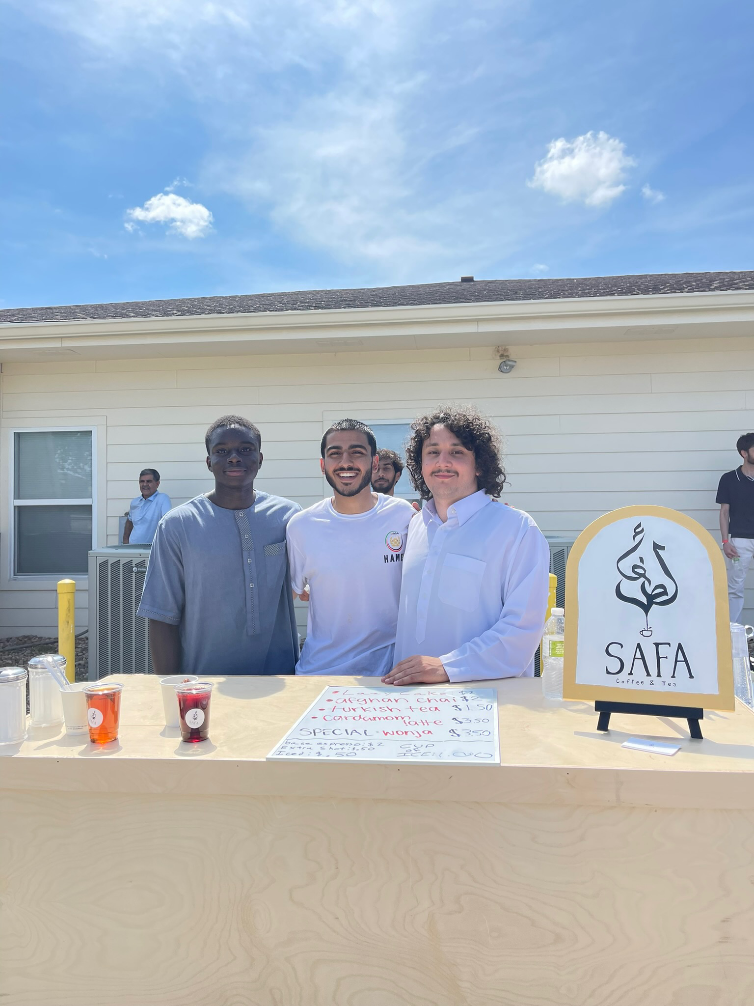 The Safa team behind their tea stand at an outdoor community event